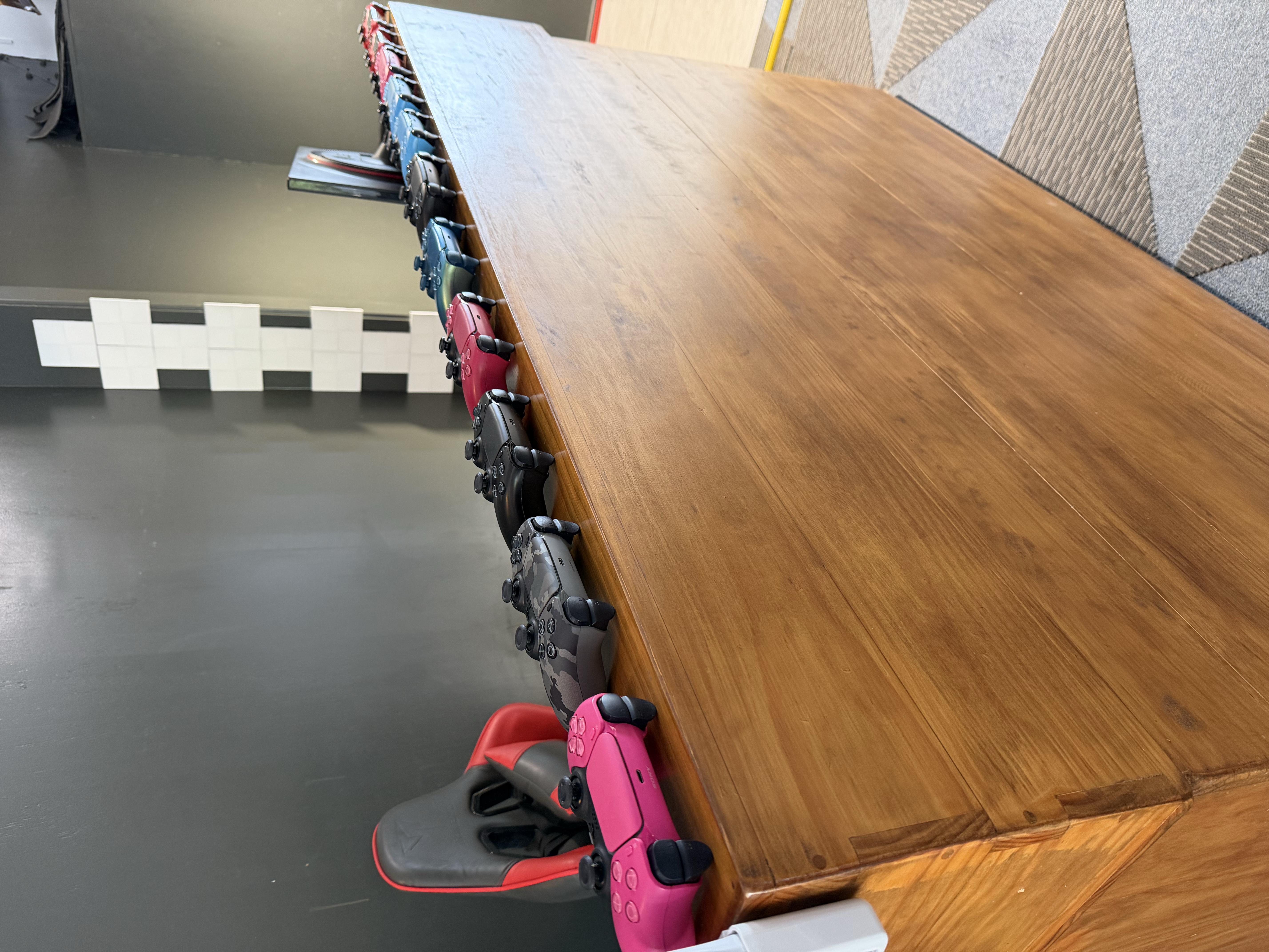 PS5 controllers lined up at Ririnui Gaming Arena, Rarotonga